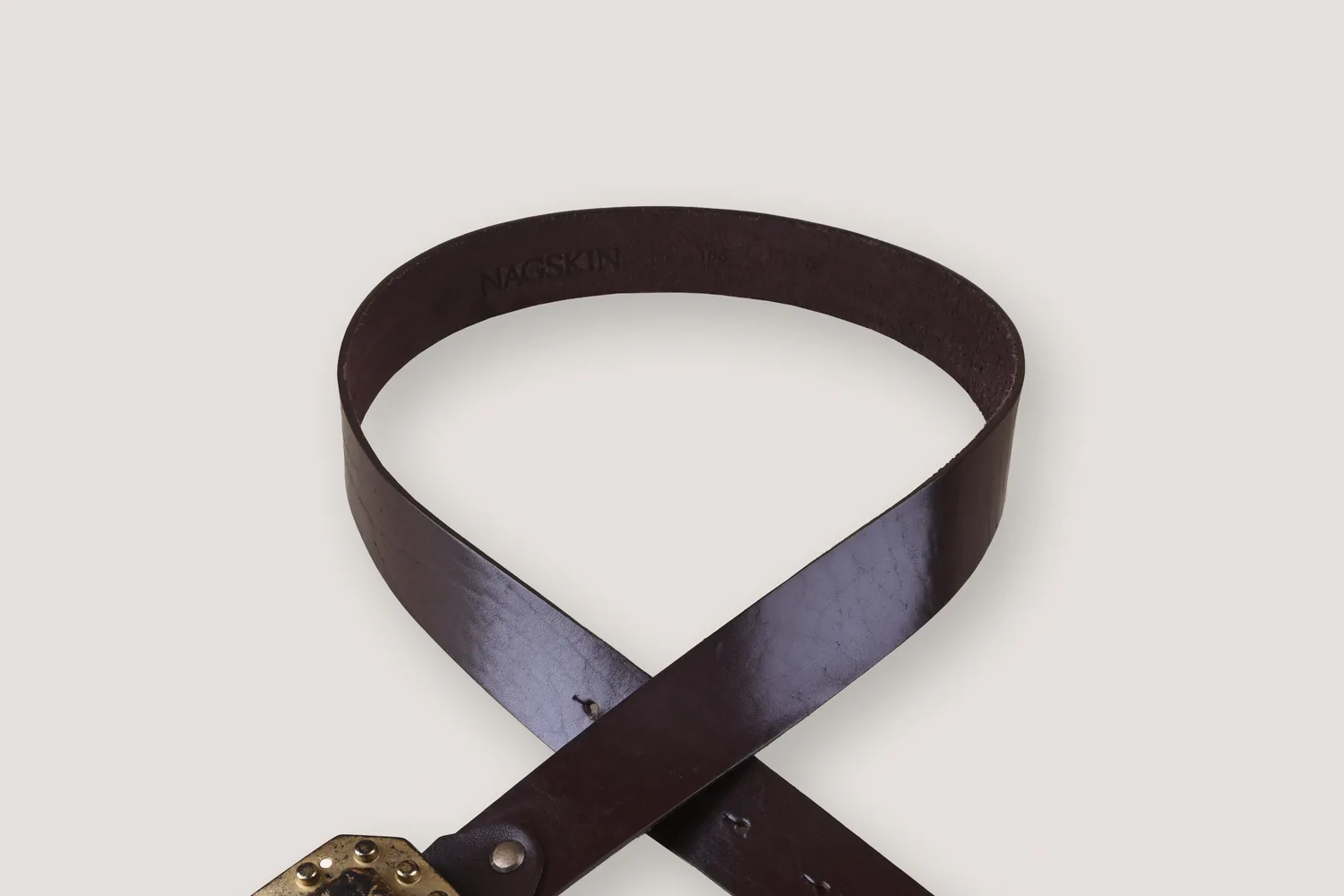 NAGSKIN leather belt styled as a minimal product composition