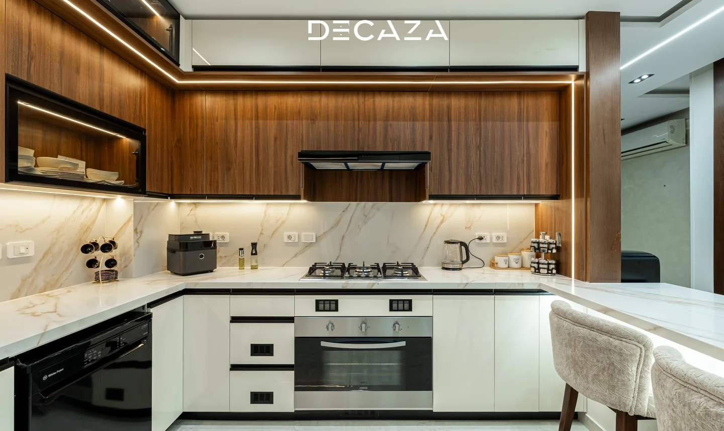 Finished Decaza kitchen with wood cabinetry and marble surfaces
