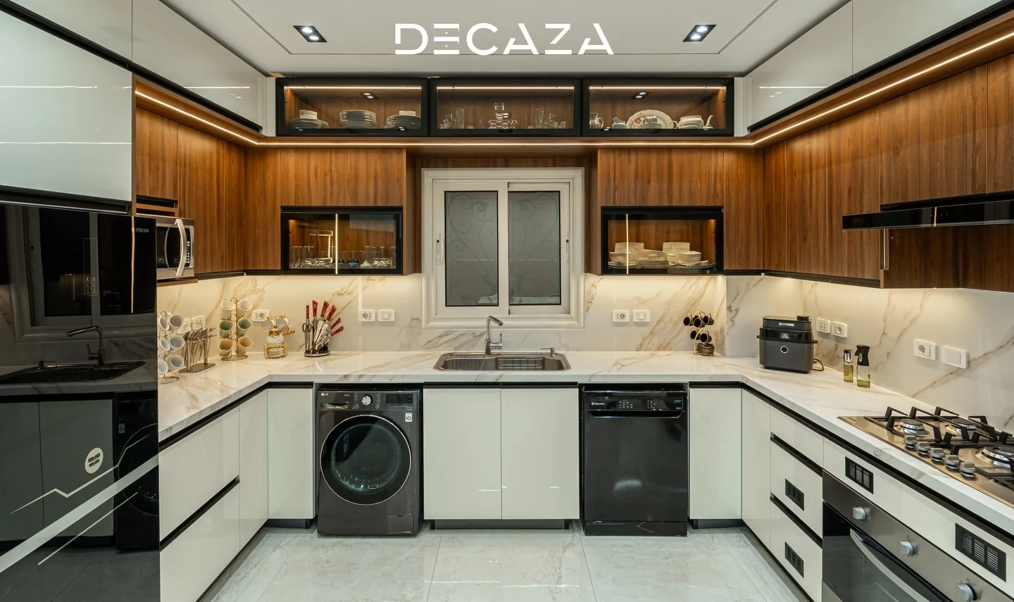 Finished Decaza kitchen with white cabinetry and warm wood