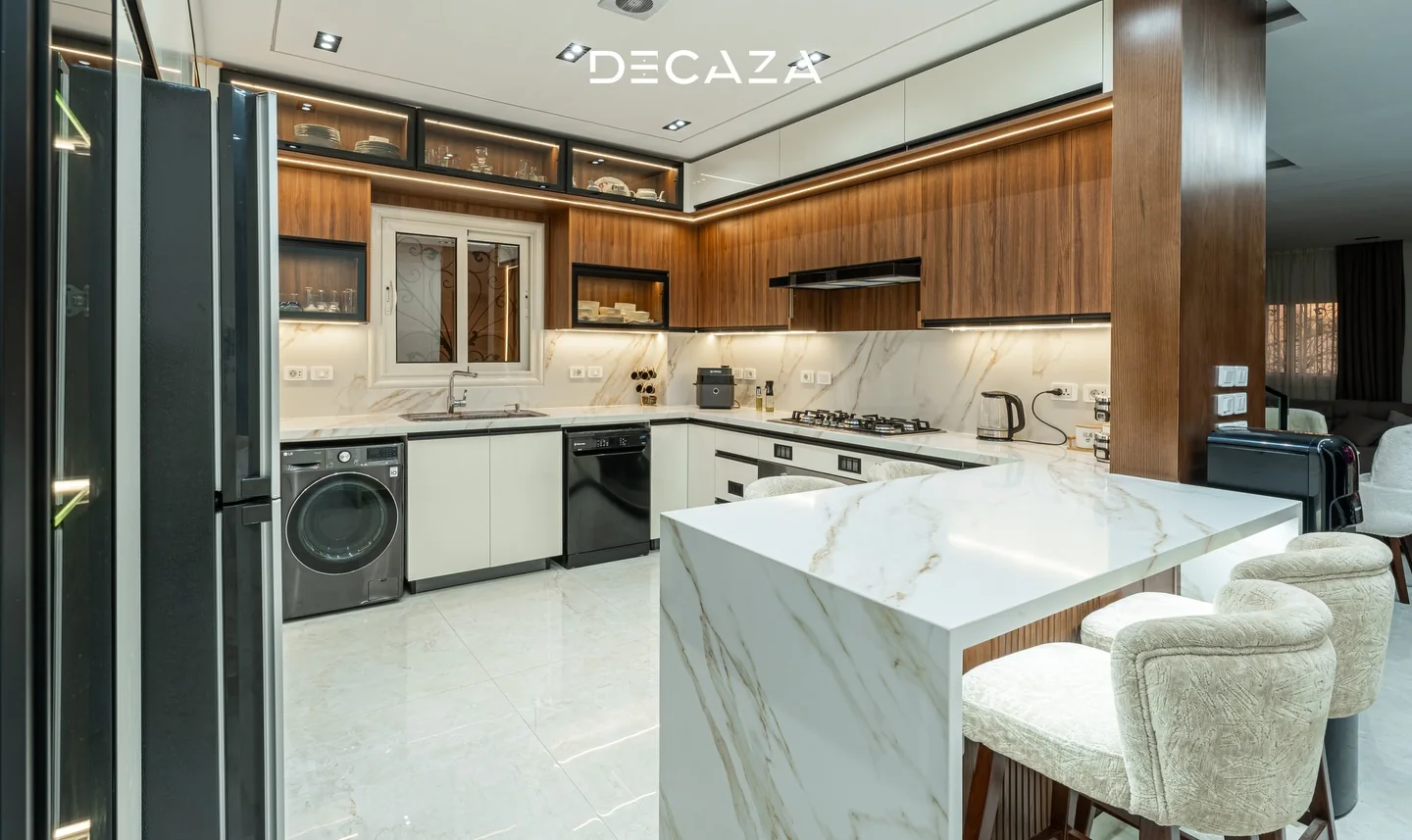 Decaza kitchen with a white island and integrated cabinetry