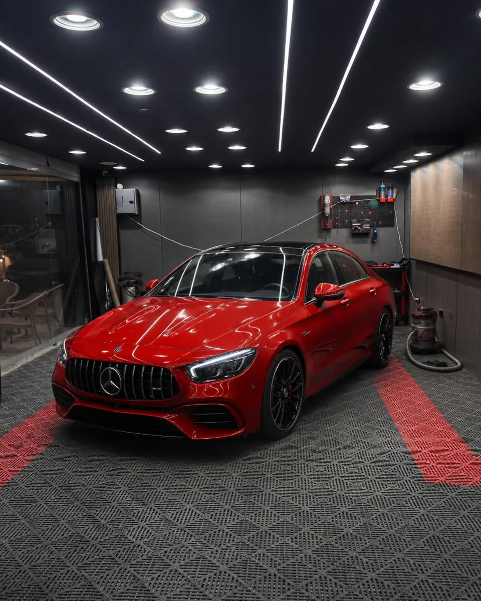 Red sedan inside the detailing bay